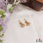 Simple White AD Gold tone Floral Jhumkas E1237