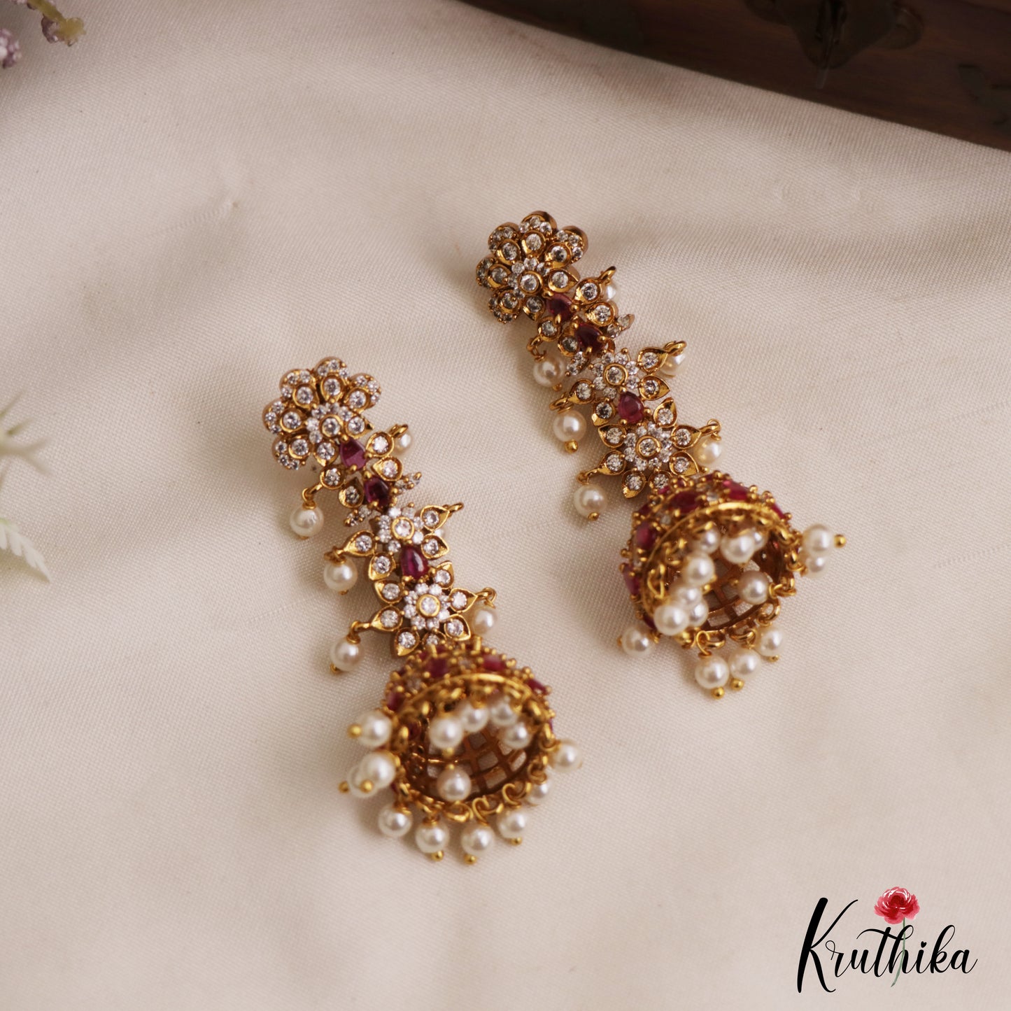 Sparkling Floral Motifs AD Jhumkas With Pearl Drops E1107 (Available In 4 Colors)