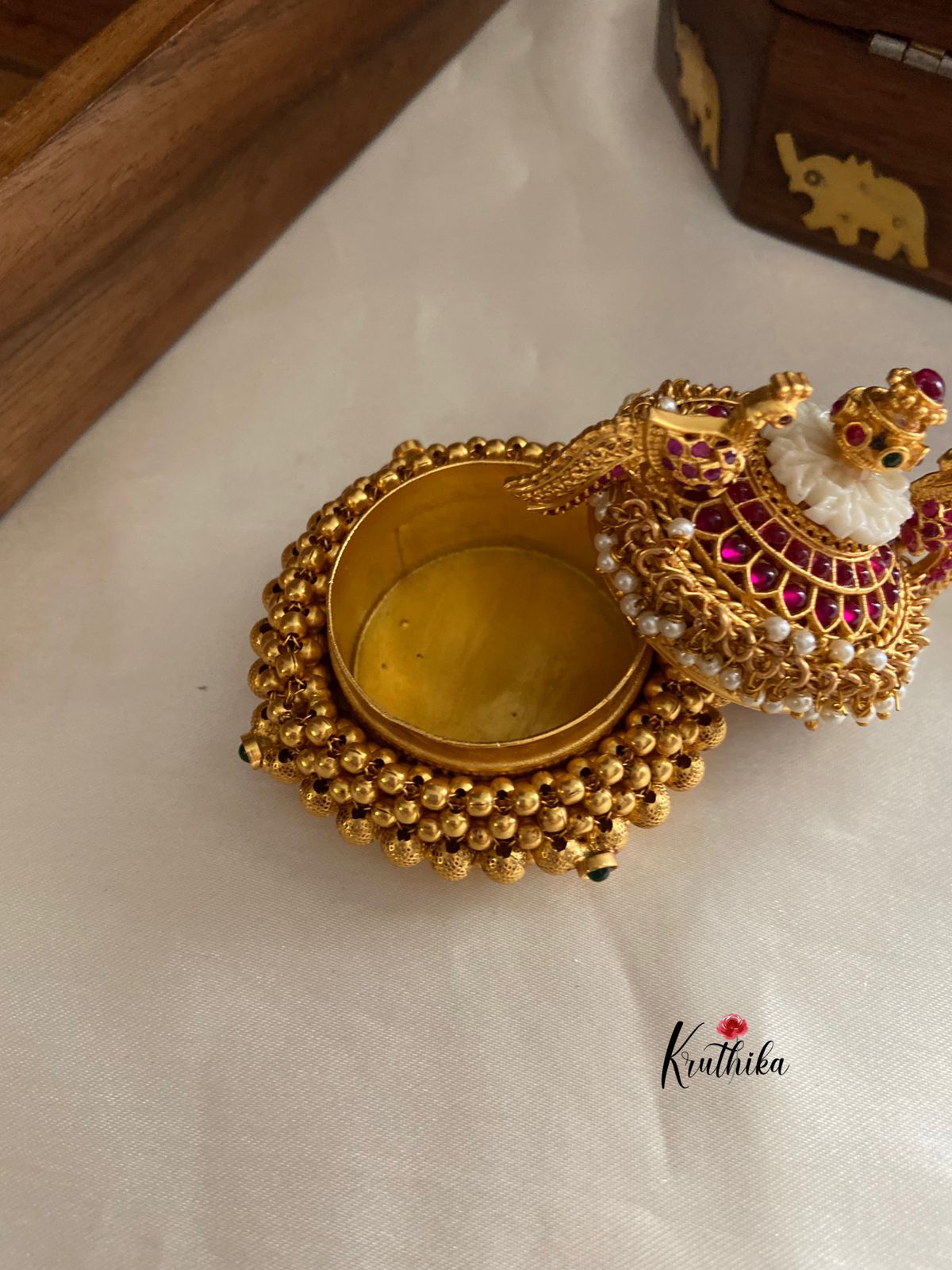 Golden beads peacock kumkuma bharini K1